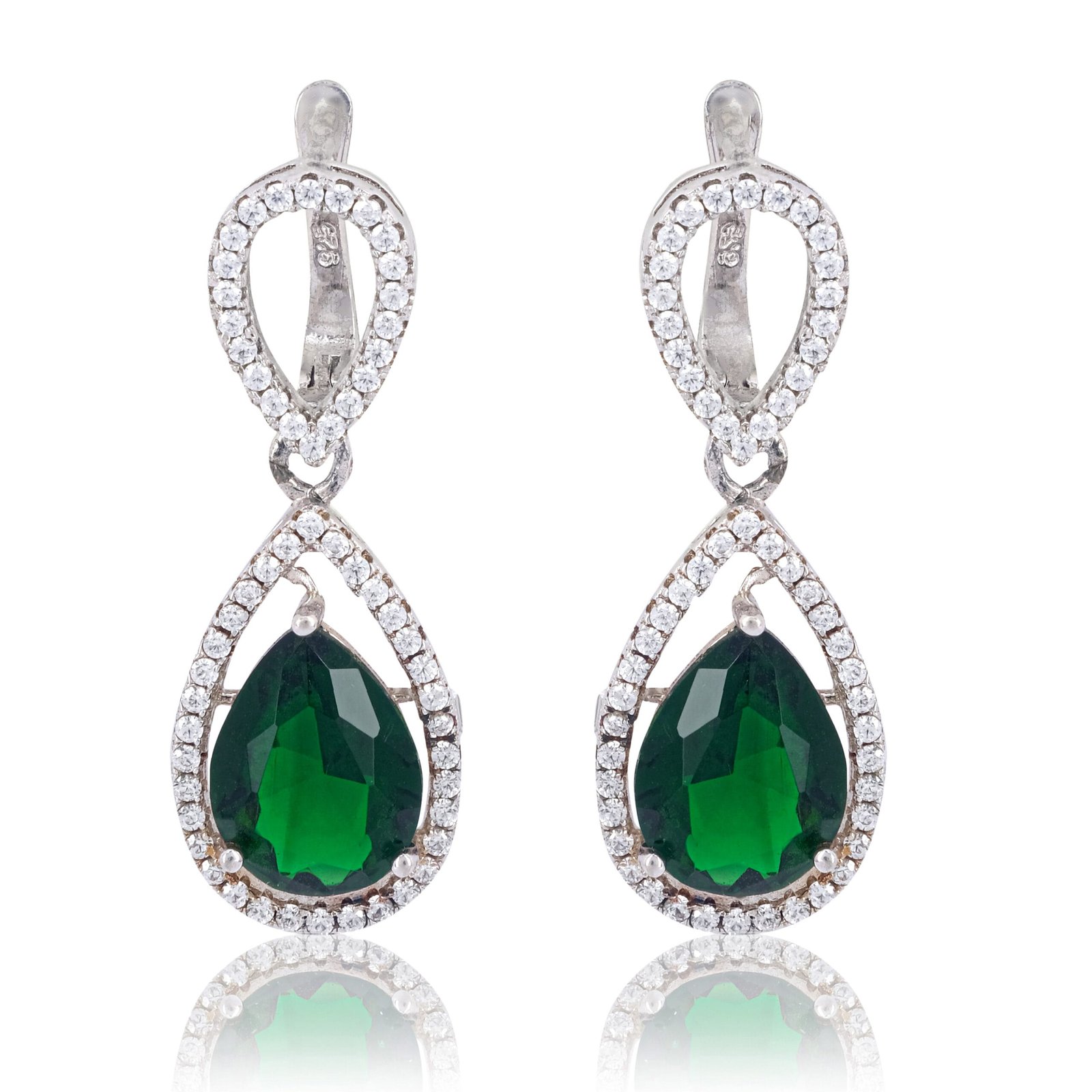 Jewelry photography of an earring with a green stone and small diamond on a white background