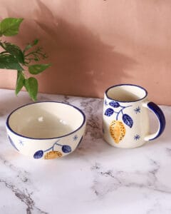 Elegant ceramic plate set styled with cutlery and napkins, captured with soft natural light by Emipix Solutions in Jaipur