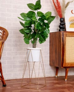 Minimalist ceramic candle holders styled with greenery, photographed for home decor brand by Emipix Solutions